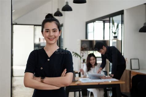 Confident Of Beautiful Asian Businesswoman Standing In Office Arms