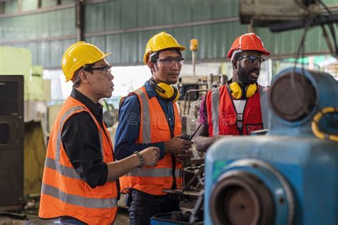 Metal Worker Teaching Trainee On Machine Engineer Men Wearing Uniform
