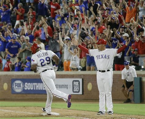 Texas Rangers First Base Coach Hector Ortiz Right And Fans Cheer As