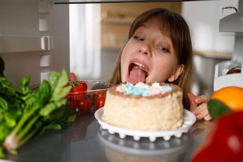 Premium Photo Woman Licking A Cake In The Fridgexa
