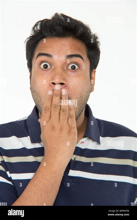 Surprised Young Man Covering His Mouth Stock Photo Alamy