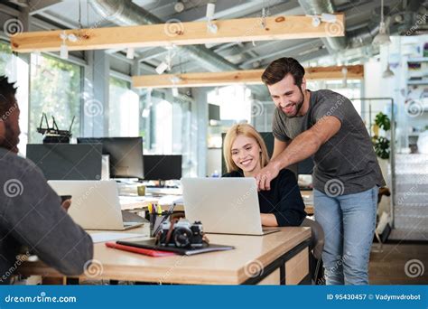 Cheerful Young Colleagues Sitting In Office Coworking Stock Image