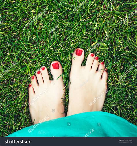 Woman Feet On The Green Grass Female Feet With Beautiful Red Nails And