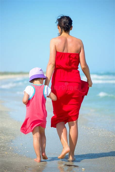 Mother With Her Little Girl Walking On The Seashore Stock Photo Image