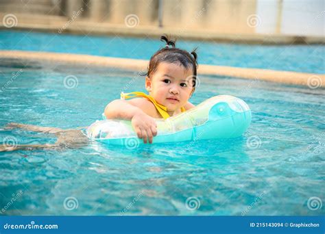 Kid Swim In The Swimming Pool On Summer Holiday Asian Little Girl