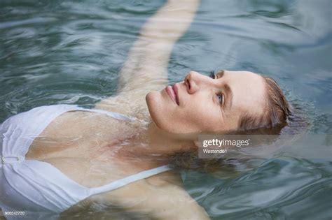 Portrait Of Relaxed Woman Floating On Water Photo Getty Images