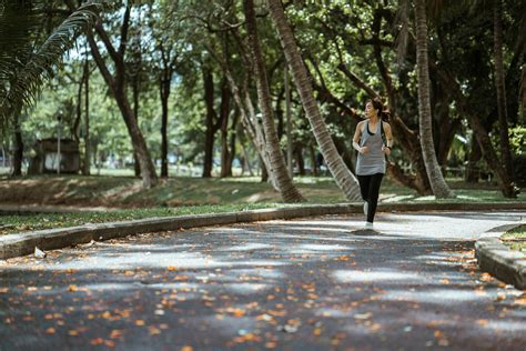 Asian Woman Jogging In Park In Sunny Day · Free Stock Photo