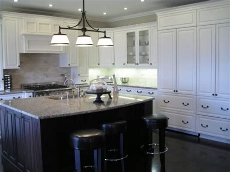 The use of white in the kitchen is a great way to keep the room cream cabinets warm up this room without darkening it and balances the dark floor and counters. White Kitchen Dark Island | Ideas for school | Pinterest ...