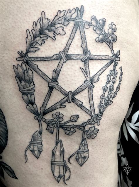 A Black And White Photo Of A Pentagramil Tattoo
