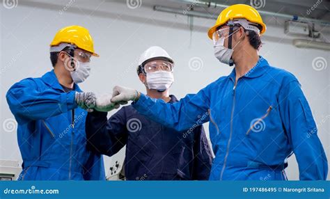 Three Of Factory Workers Men Wearing Mask Stand With Action Of Fighting