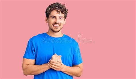 Young Handsome Man With Curly Hair Wearing Casual Clothes With Hands