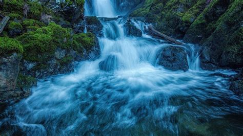 Waterfall On Algae Plants Covered Rocks Mountain Stream During Evening