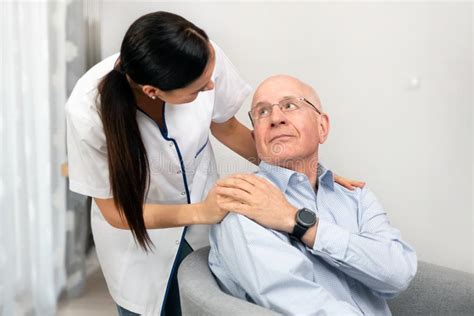 Smiling Nurse And Old Senior Man Patient At Home Stock Photo Image Of