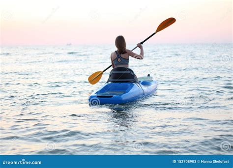 Kayaking Woman In Kayak Girl Rowing In The Water Of A Calm Sea Stock