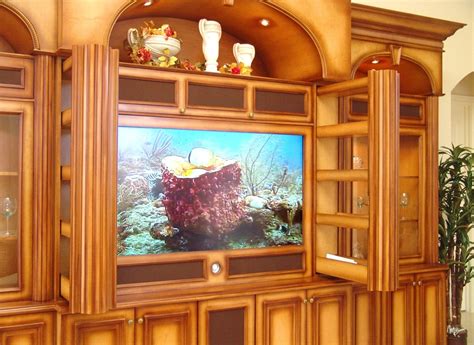 A Large Entertainment Center With An Aquarium On The Wall