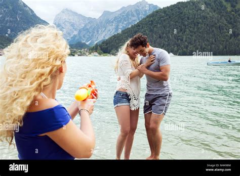 Woman Squirting Water Pistol At Friends Innsbruck Tirol Austria