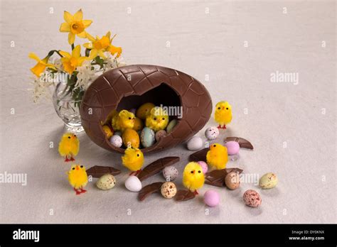 Easter Egg Broken With Eggs And Chicks Falling Out Spring Flowers And