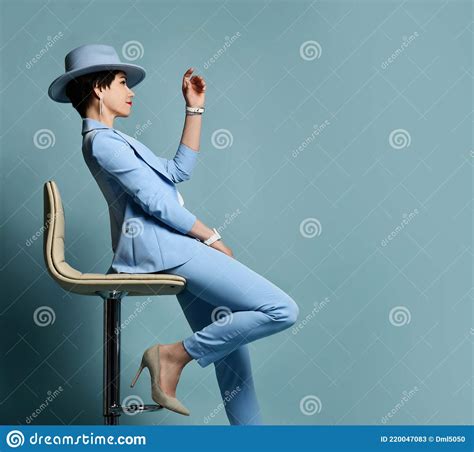 Attractive Smiling Short Haired Brunette Woman In Blue Business Smart Casual Suit Shoes Hat