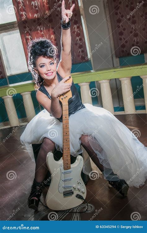 Photo Of A Female Guitarist Playing An Electric Guitar Stock Photo