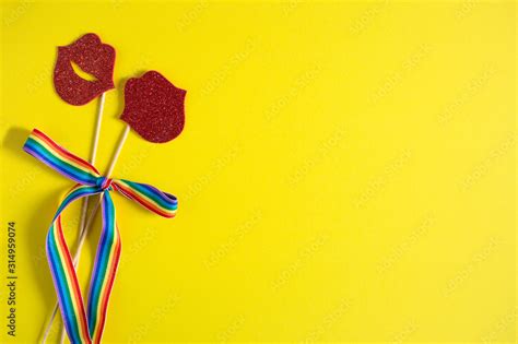Paper Kisses On A Stick Are Tied With A Rainbow Ribbon On A Yellow Background Lesbians Lgbt