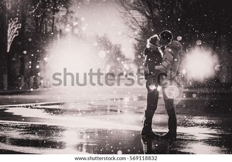 In Love Couple Kissing In The Snow At Night City Street Black And White