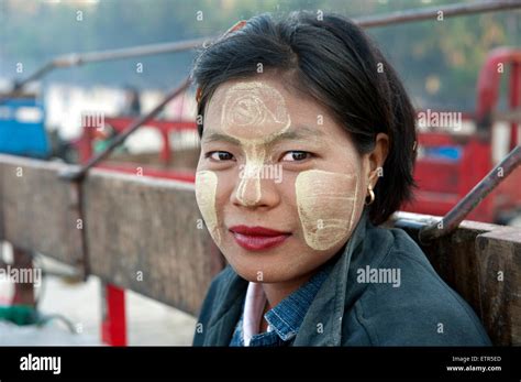 Portrait Of A Pretty Burmese Woman With Sandalwood Designs On Her Face