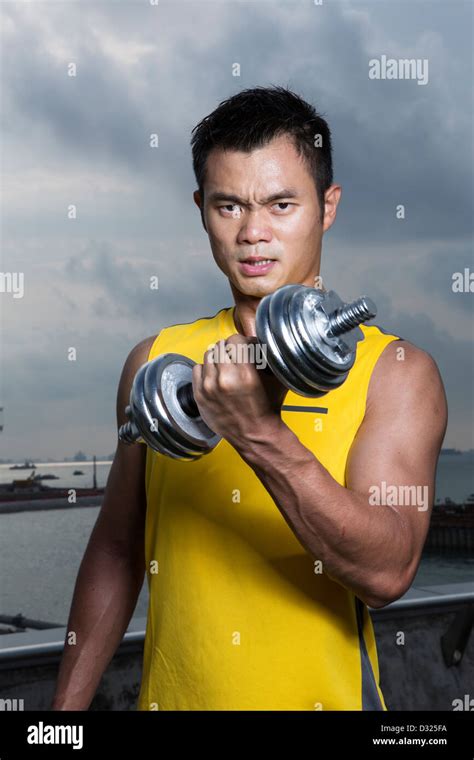 Athletic Young Chinese Man Exercising With Dumbbells Muscular Asian