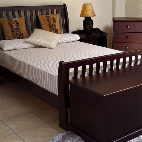 Nice queen slay bed frame, easy to put together, wood color goes with a lot, and slates included. BUD SLEIGH BED (QUEEN) 'MAHOGANY'