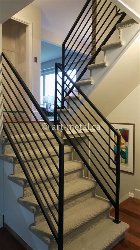 Modern staircase in foyer with lights and glass balustrade. Contemporary Interior Stair Railings for Your Modern Home