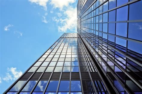 Gray Glass Window High Rise Building With Sky Reflection · Free Stock Photo