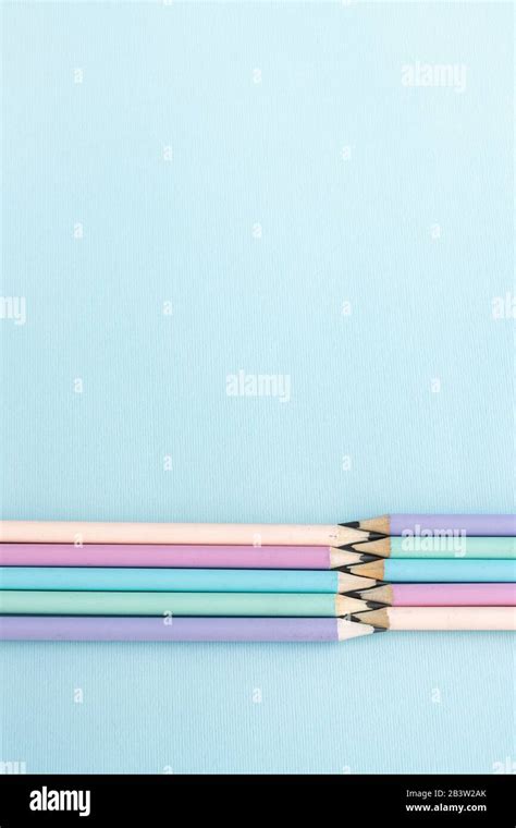 Pastel Colored Pencils On Empty Sheet Blue Toned Stock Photo Alamy
