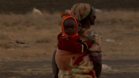 Woman Carrying Child on Her Back in Kenya Stock Video Footage - Storyblocks