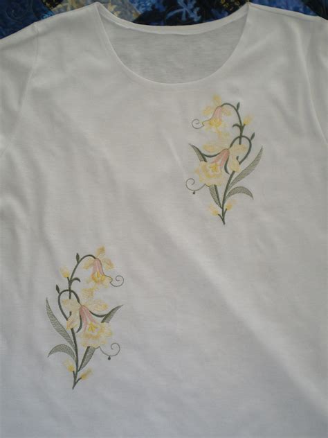 Two T-shirts with embroidered flowers