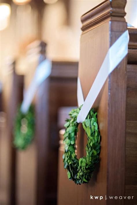 Pew Markers Of Petite Boxwood Wreaths Were Hung With Cream Stain Ribbon