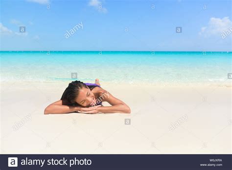 Relaxing Woman On Beach Vacation Sleeping On Sand Beautiful Girl Lying Down Under The Sun