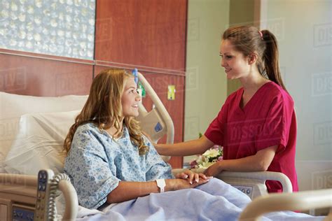 Nurse Talking To Female Teenage Patient In Hospital Stock Photo