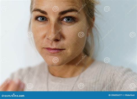 Selective Focus On The Face Of A Blonde Woman With A Tired Face While