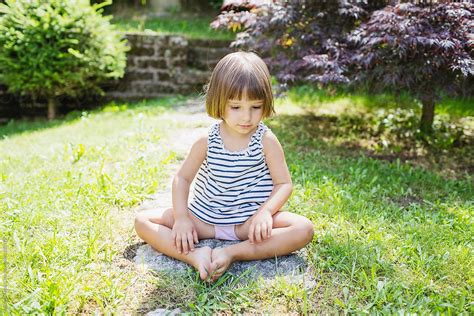 Little Girl Sitting In The Garden By Michela Ravasio Stocksy United