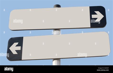 Two Signs Pointing In Opposite Direction With Copy Space And Blue Sky
