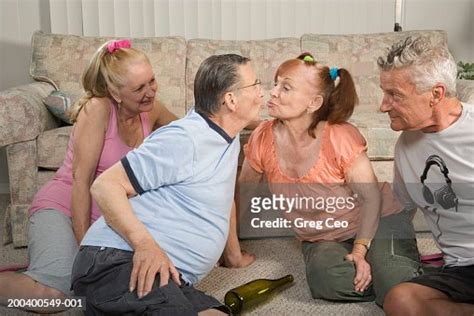 Senior Couples Playing Spin The Bottle Side View Closeup High Res Stock