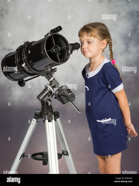 Girl Lover Of Astronomy With Interest Looks In The Eyepiece Of The