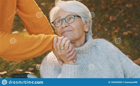 Old Couple Having Romantic Autumn Day In Forest Hugging Tree And