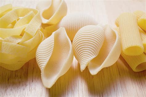 Various Types Of Pasta On Wooden Background Photograph By