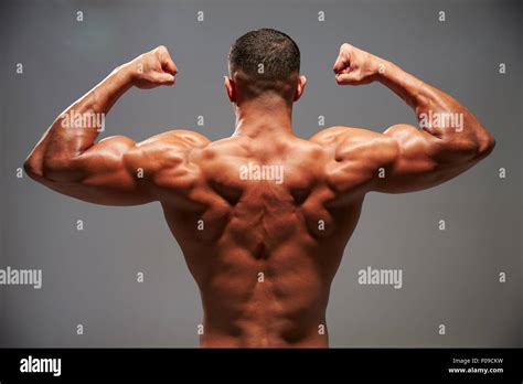 Male Bodybuilder Flexing His Biceps Back View Stock Photo Alamy