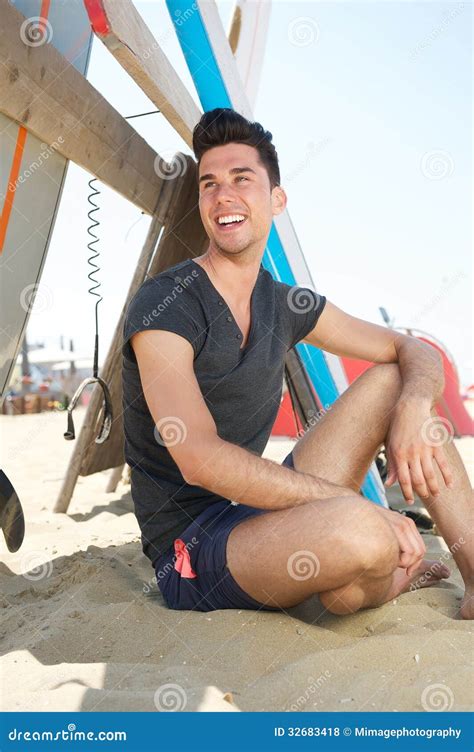 Homem Novo Feliz Que Sorri Na Praia Foto De Stock Imagem De Areia