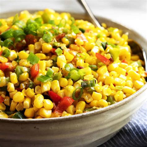 2 tablespoons (1/4 stick) butter, 1 cup finely chopped onion, 1/2 cup chopped red bell pepper, 2 cups fresh corn kernels (cut from 3 medium ears of corn), 3/4 cup heavy whipping cream, 1 teaspoon chopped fresh thyme, 1/2 teaspoon (or more) hot pepper sauce, 1 green onion. Easy Corn Maque Choux Recipe - Pinch and Swirl