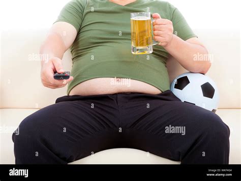 Fat Man Drinking Beer And Sitting On Sofa To Watch TV Stock Photo Alamy
