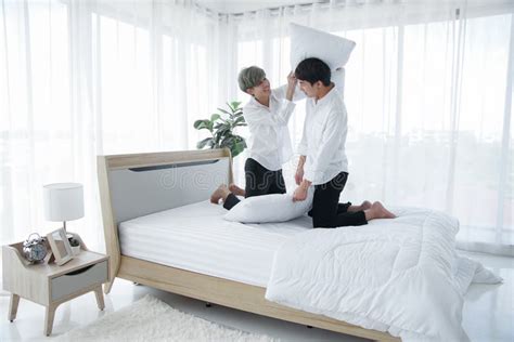 Lgbt Asian Gay Couple In White Bedroom Young Man Smiling Lying On Bed Putting His Chin On