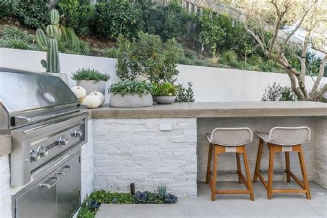 White Brick Outdoor Kitchen With Concrete Countertop Transitional