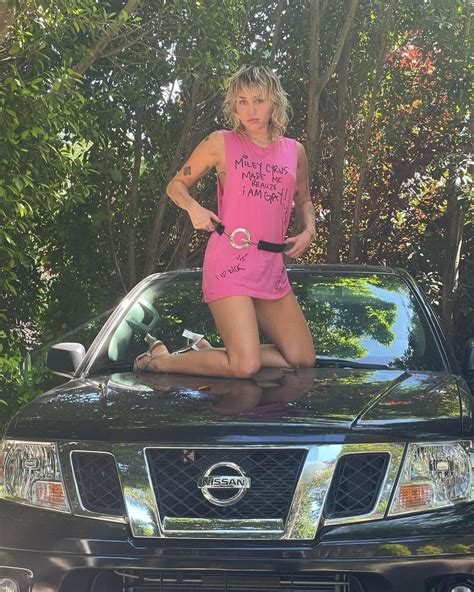 Miley Cyrus Poses On Dad Billy Ray Cyrus Truck In NSFW Graphic Tee